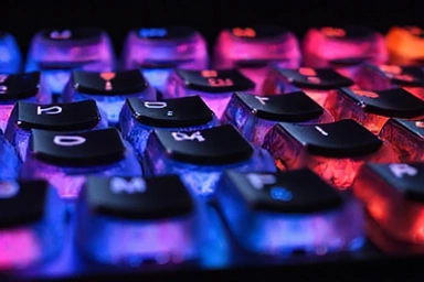 A close-up of an RGB mechanical keyboard with vibrant backlighting.